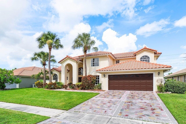 mediterranean / spanish-style home featuring a front yard