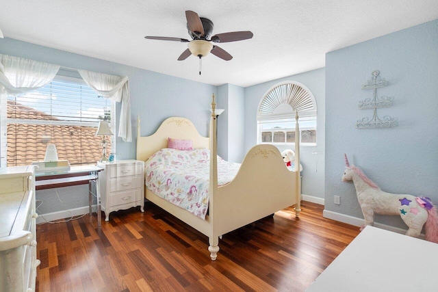 bedroom featuring ceiling fan, dark wood-type flooring, and a textured ceiling