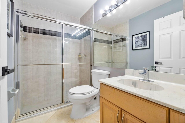 bathroom with vanity, toilet, walk in shower, and tile patterned floors