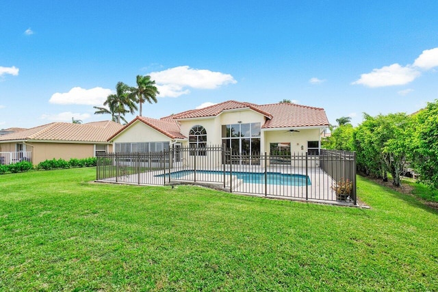 view of pool with ceiling fan, a patio area, and a lawn