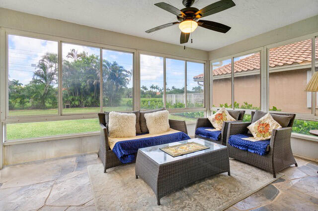 sunroom with ceiling fan and a wealth of natural light