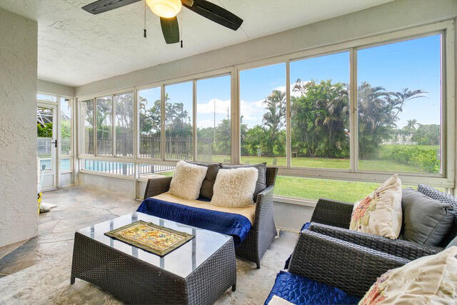 sunroom featuring ceiling fan