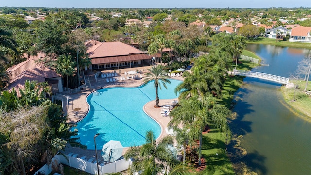 view of pool with a patio area and a water view