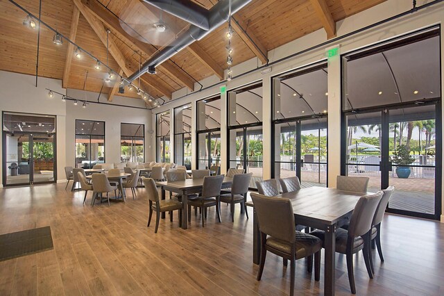 dining room with wood ceiling, wood-type flooring, french doors, beamed ceiling, and high vaulted ceiling