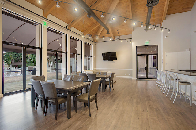 dining room featuring hardwood / wood-style flooring, beamed ceiling, high vaulted ceiling, and wood ceiling