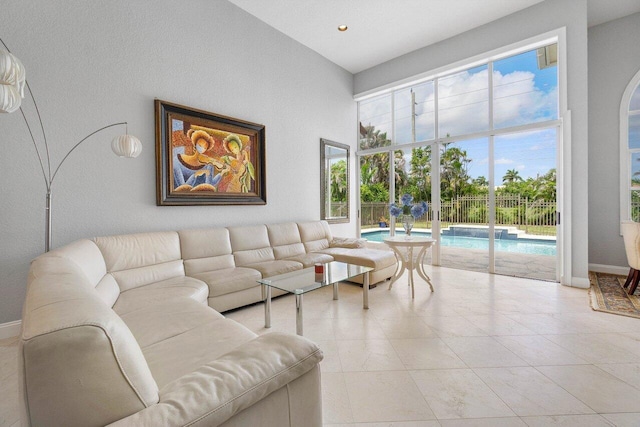 living room featuring plenty of natural light and a towering ceiling