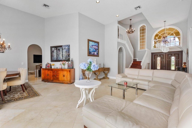 living room with a high ceiling and an inviting chandelier