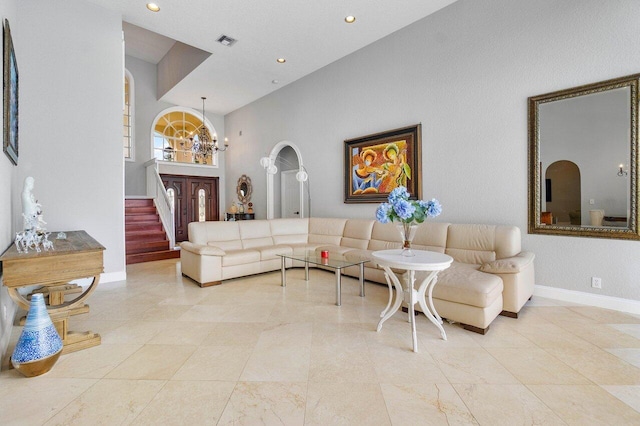 living room featuring a high ceiling and a chandelier