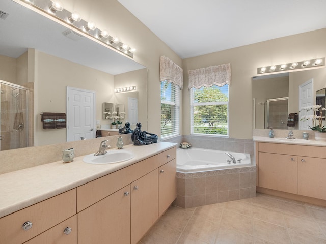 bathroom featuring tile patterned floors, vanity, and separate shower and tub