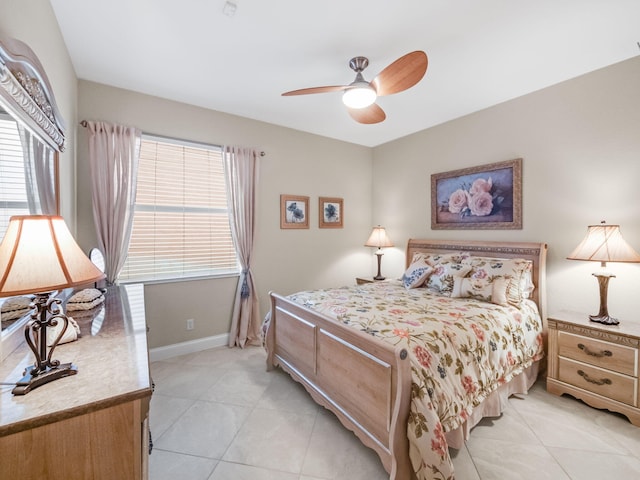 bedroom with light tile patterned flooring, multiple windows, and ceiling fan