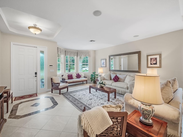 tiled living room with a tray ceiling