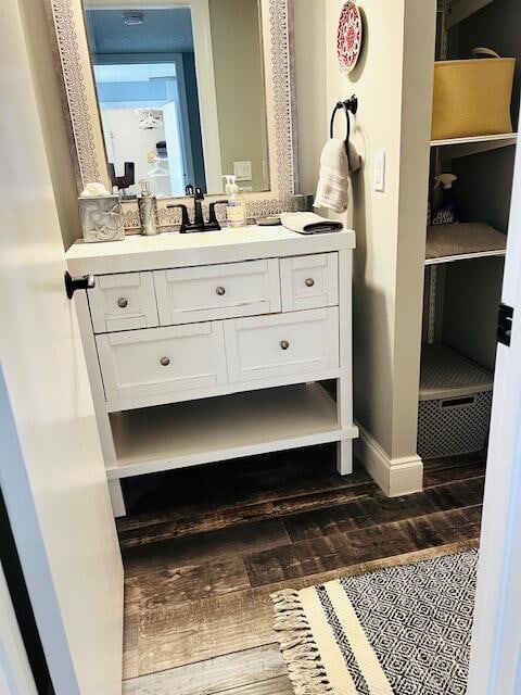 bathroom with hardwood / wood-style flooring and vanity