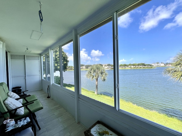 unfurnished sunroom with a water view