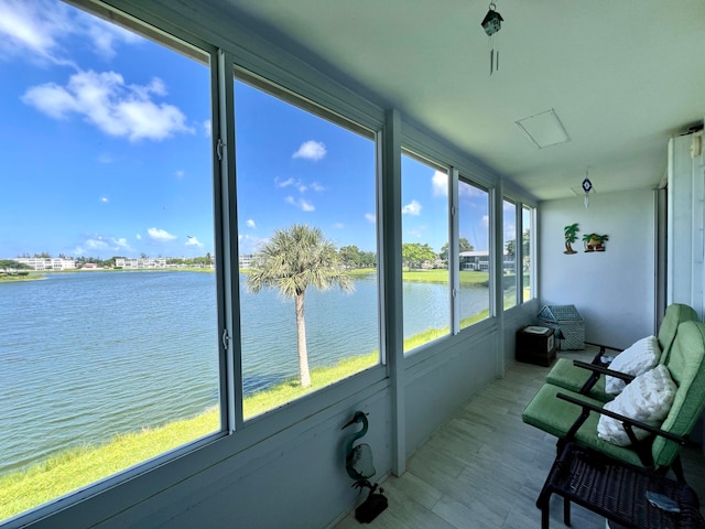 sunroom / solarium with a water view and a wealth of natural light