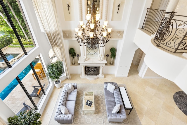 living room featuring light tile patterned floors, a chandelier, and a high ceiling