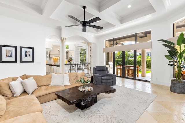 tiled living room with ceiling fan, beam ceiling, coffered ceiling, and plenty of natural light