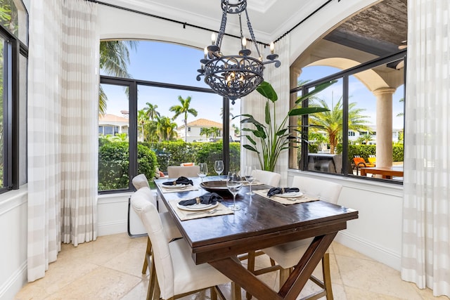 tiled dining space with an inviting chandelier and ornamental molding