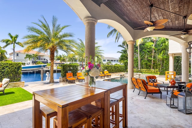 view of patio / terrace with a water view and ceiling fan