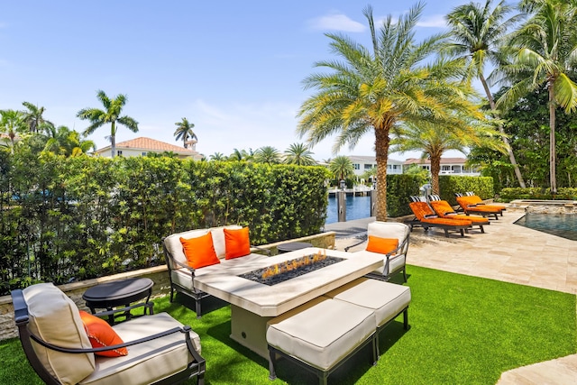 view of patio with a water view and an outdoor fire pit