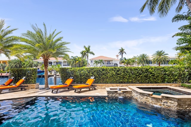 view of pool featuring a patio and an in ground hot tub