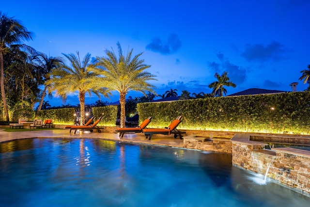 view of swimming pool with pool water feature and a patio area