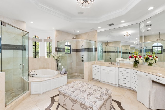 bathroom featuring tile patterned flooring, shower with separate bathtub, vanity, and a tray ceiling