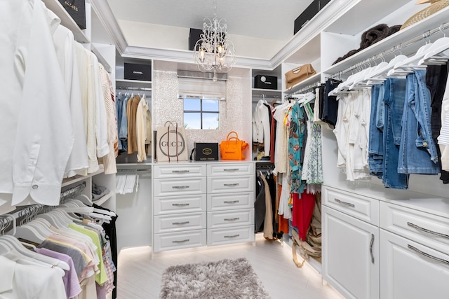 spacious closet with a chandelier