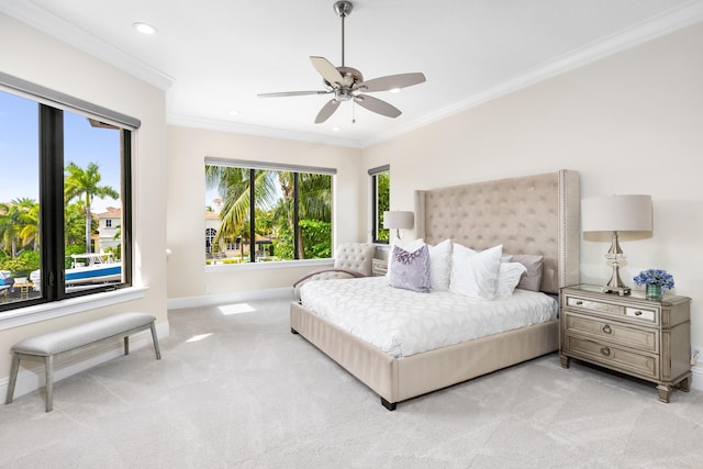 bedroom featuring crown molding, ceiling fan, and light colored carpet