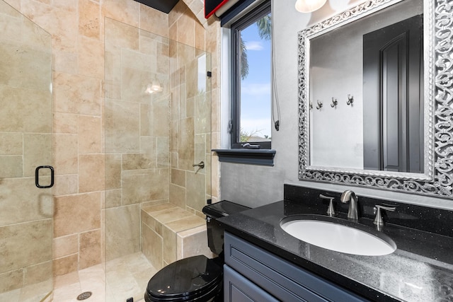 bathroom featuring vanity, toilet, and an enclosed shower