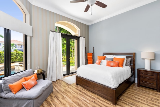 bedroom featuring light hardwood / wood-style flooring, multiple windows, and ceiling fan