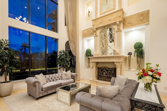 interior space with a high end fireplace and a high ceiling