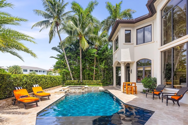 view of swimming pool featuring an in ground hot tub and a patio area