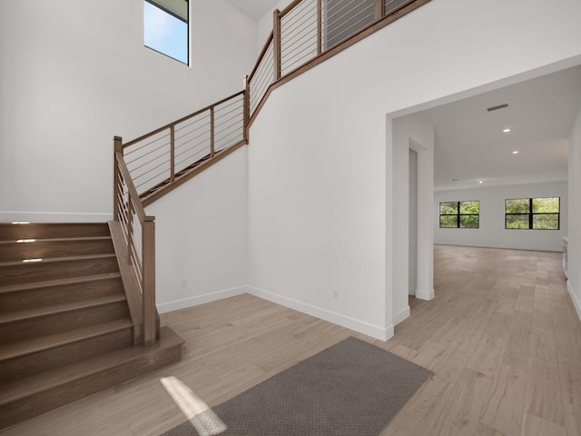 stairs with hardwood / wood-style floors