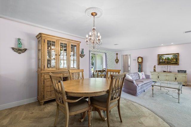 carpeted dining room with an inviting chandelier, baseboards, visible vents, and ornamental molding