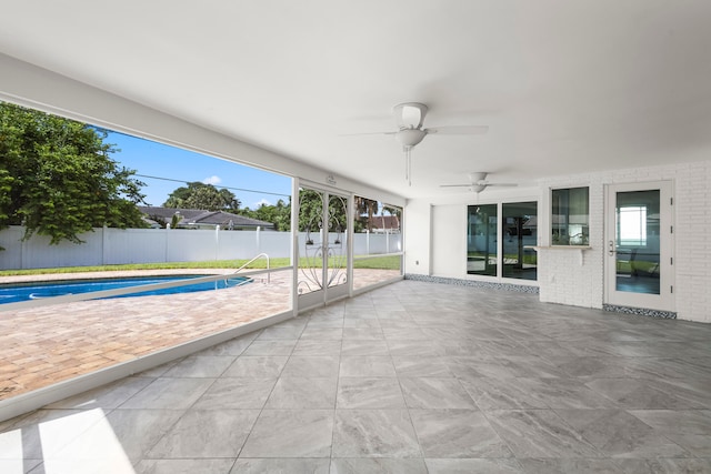 view of patio / terrace featuring a fenced in pool and ceiling fan