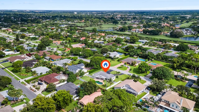 aerial view featuring golf course view, a water view, and a residential view