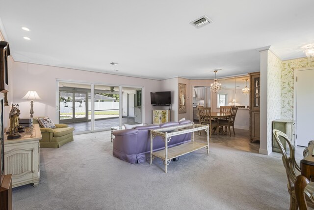 carpeted living room with a notable chandelier and crown molding