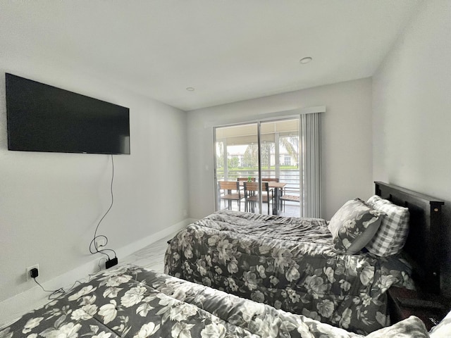 bedroom featuring baseboards, marble finish floor, and access to exterior