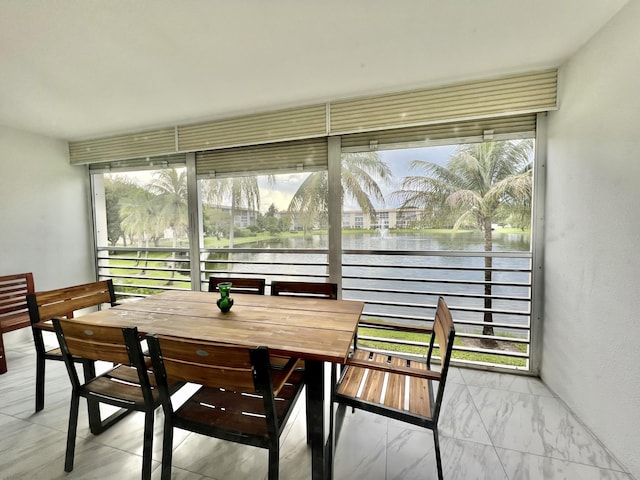 sunroom with a water view and a wealth of natural light