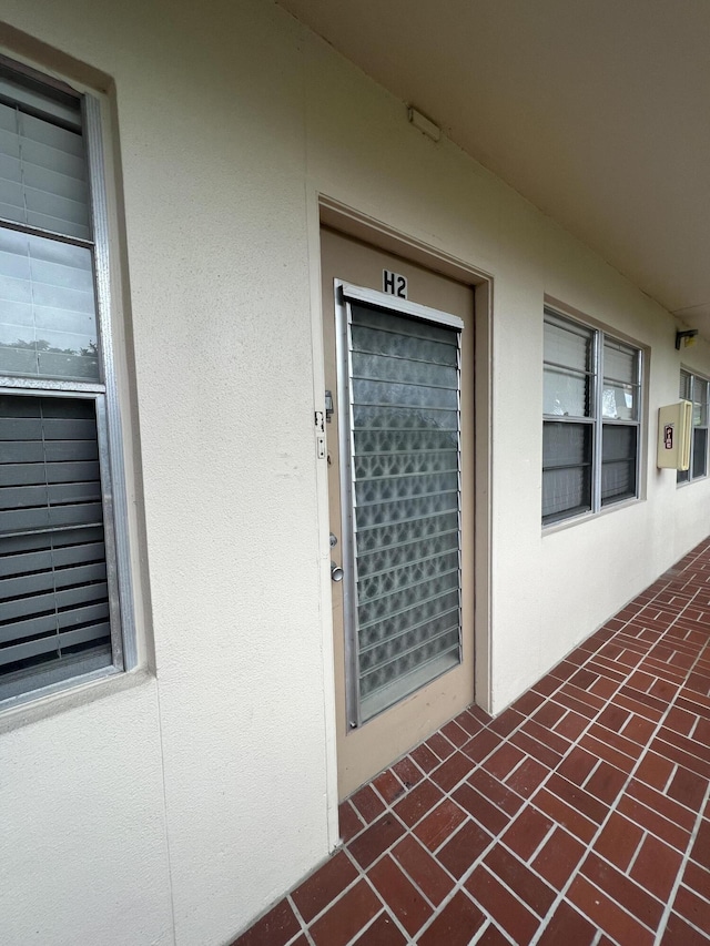 entrance to property with stucco siding