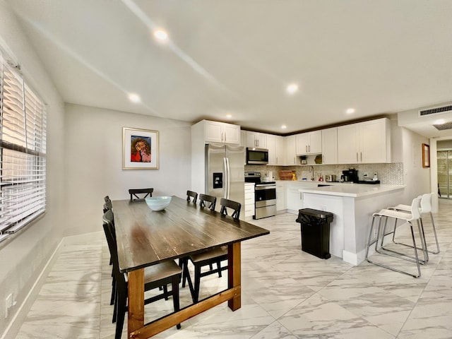 dining space featuring marble finish floor, baseboards, visible vents, and recessed lighting