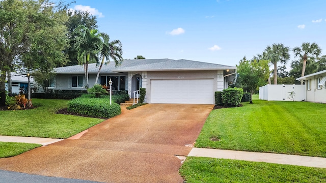 view of front of home with a garage and a front yard