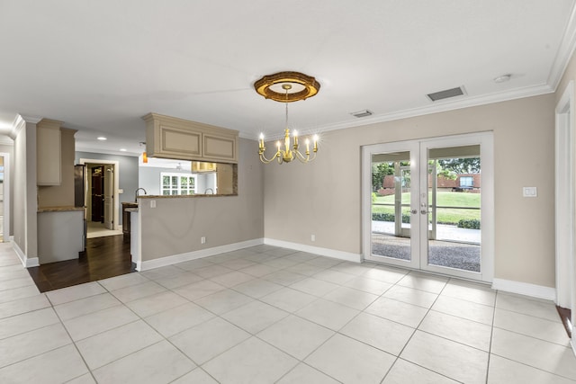 unfurnished room with light tile patterned flooring, ornamental molding, and an inviting chandelier