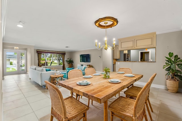 dining space featuring an inviting chandelier, crown molding, and light tile patterned floors