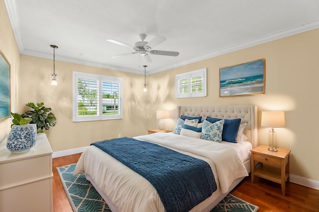 bedroom with crown molding, hardwood / wood-style floors, and ceiling fan