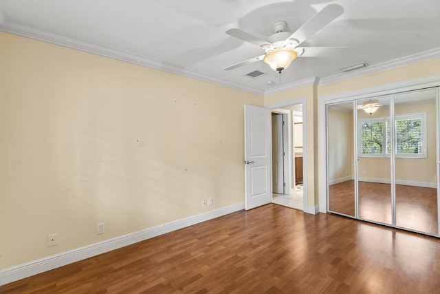 unfurnished bedroom featuring ceiling fan, ornamental molding, and hardwood / wood-style floors