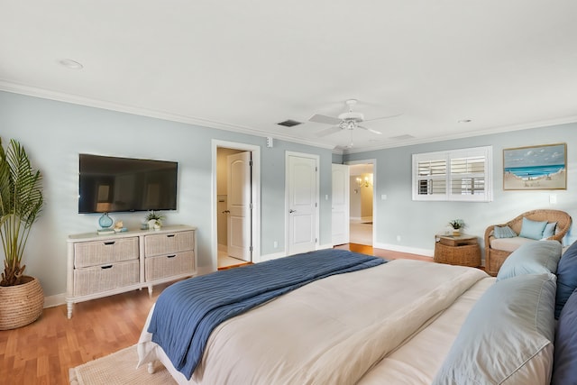 bedroom featuring hardwood / wood-style flooring, ornamental molding, and ceiling fan