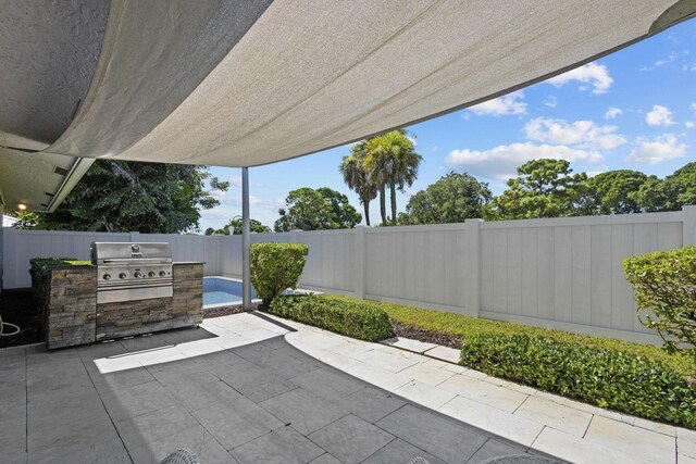 view of patio featuring grilling area and exterior kitchen