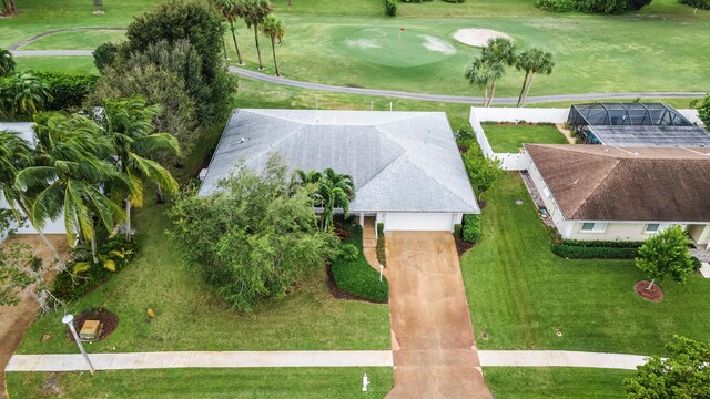 single story home featuring a garage and a front lawn