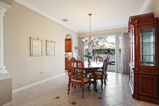 dining room featuring light tile patterned flooring, baseboards, visible vents, arched walkways, and ornamental molding